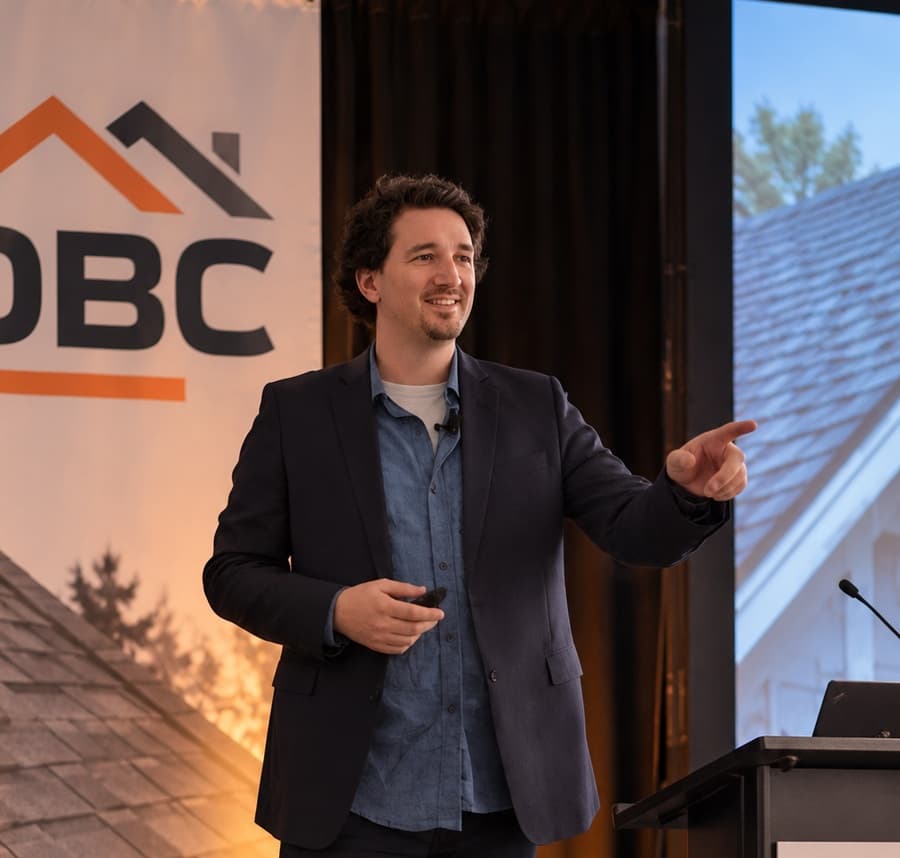 Ontario Roofers speaking on stage at a roofing industry event